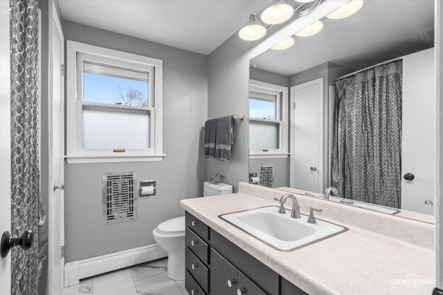 bathroom with a healthy amount of sunlight, a baseboard heating unit, vanity, and toilet