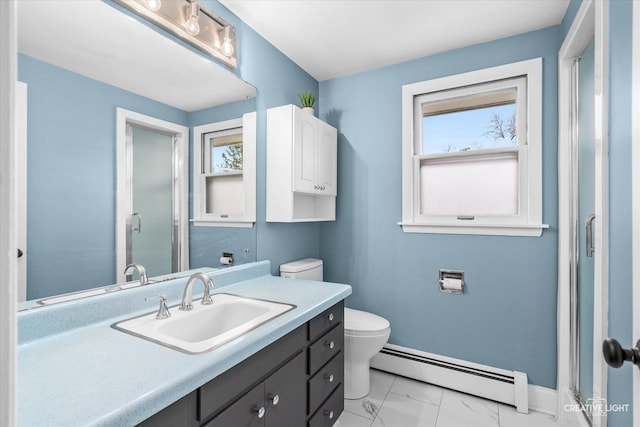 bathroom featuring a baseboard radiator, vanity, and toilet