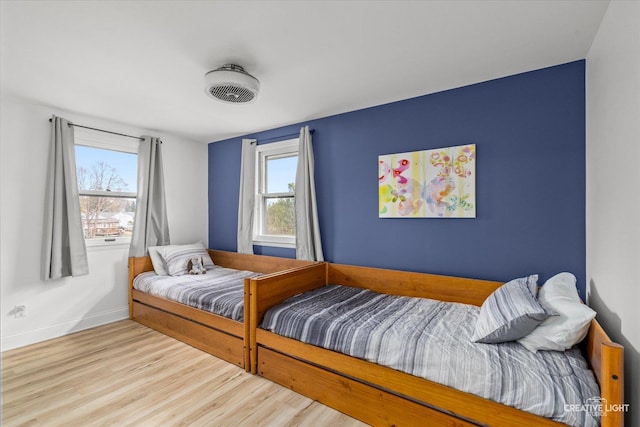 bedroom with light hardwood / wood-style floors