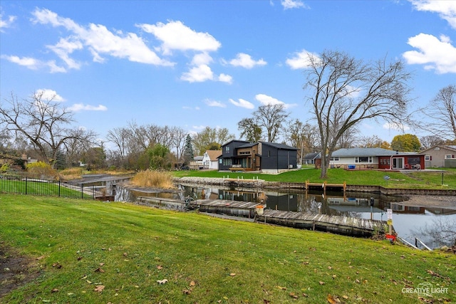 view of dock featuring a water view and a lawn