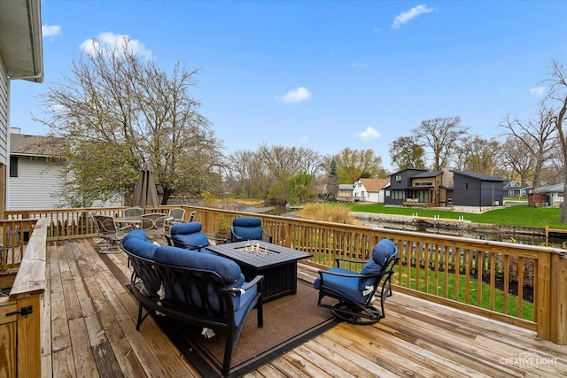 wooden terrace featuring an outdoor fire pit