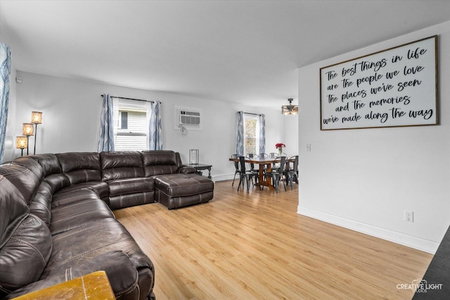 living room featuring wood-type flooring and a wall mounted air conditioner