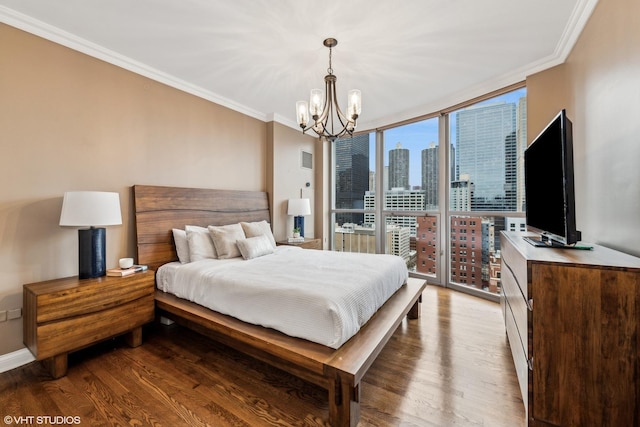 bedroom featuring light hardwood / wood-style flooring, a wall of windows, ornamental molding, and an inviting chandelier