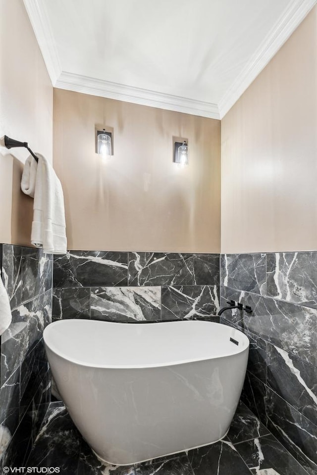 bathroom featuring ornamental molding and a tub