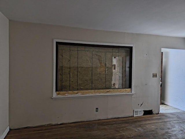 spare room with dark wood-type flooring