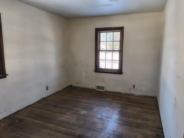 empty room featuring dark hardwood / wood-style flooring