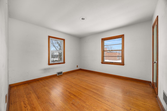 empty room featuring plenty of natural light and light wood-type flooring