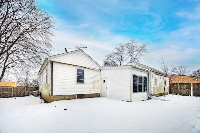 view of snow covered back of property