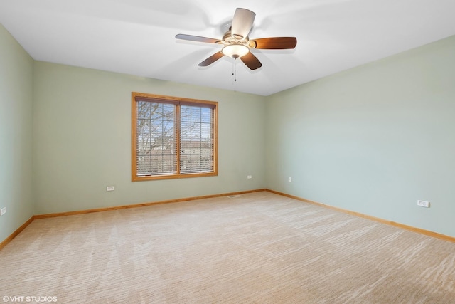 empty room with light colored carpet and ceiling fan