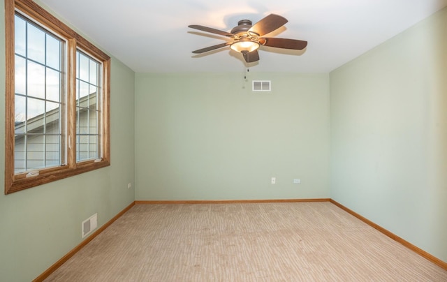 unfurnished room featuring light colored carpet and ceiling fan