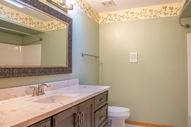 bathroom featuring vanity and toilet