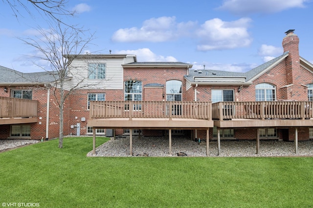 back of house with a lawn and a deck