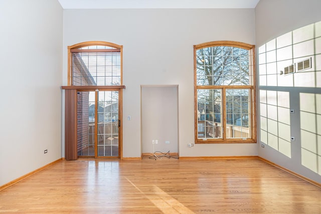 unfurnished room with light wood-type flooring