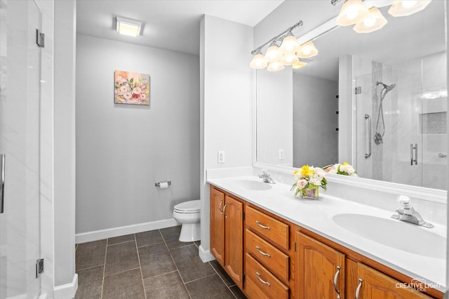 full bath featuring a stall shower, a sink, and toilet