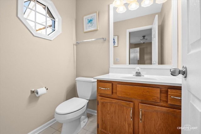 bathroom with baseboards, vanity, toilet, and tile patterned floors