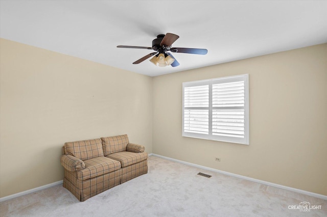 living area with ceiling fan, carpet, visible vents, and baseboards