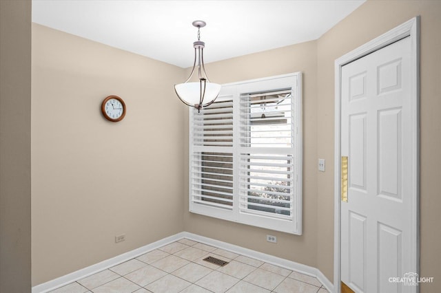 unfurnished dining area featuring light tile patterned floors, visible vents, and baseboards