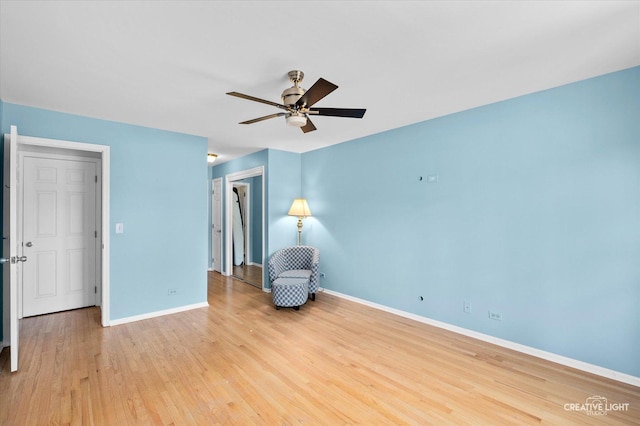 unfurnished room with ceiling fan, baseboards, and wood finished floors