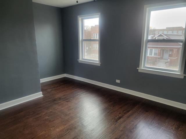 unfurnished room with dark hardwood / wood-style flooring