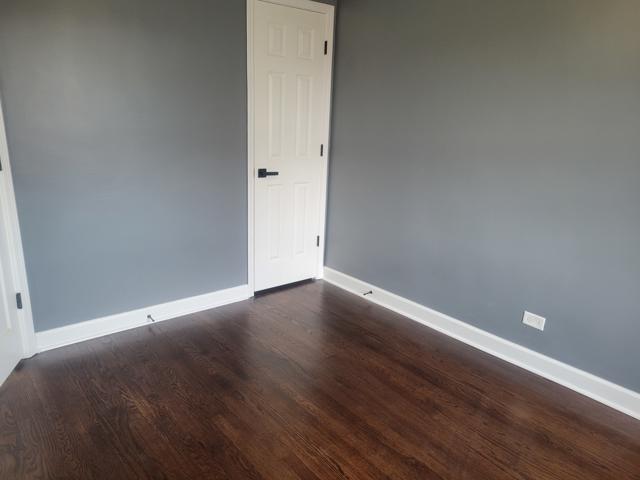 empty room with dark hardwood / wood-style floors