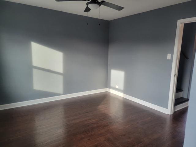 spare room featuring dark hardwood / wood-style flooring and ceiling fan