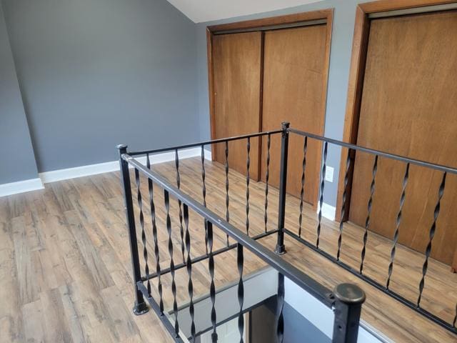 stairway with hardwood / wood-style floors