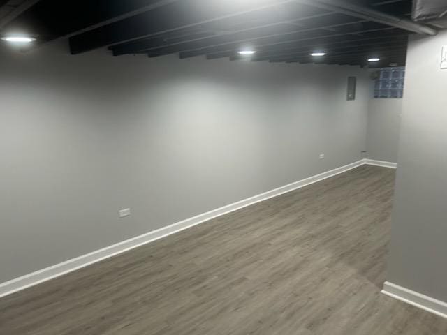 basement featuring dark hardwood / wood-style floors