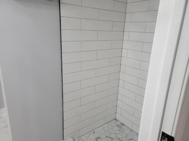 bathroom with tiled shower