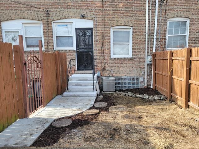 doorway to property with central AC unit