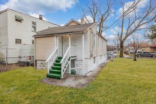 rear view of property with a lawn