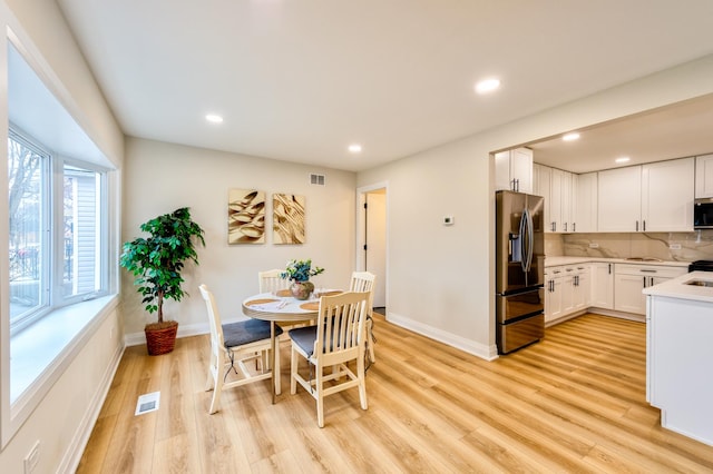 dining space with light hardwood / wood-style flooring