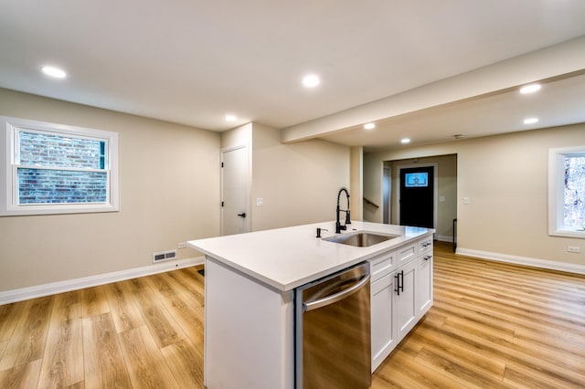 kitchen featuring sink, dishwasher, a kitchen island with sink, white cabinets, and light wood-type flooring