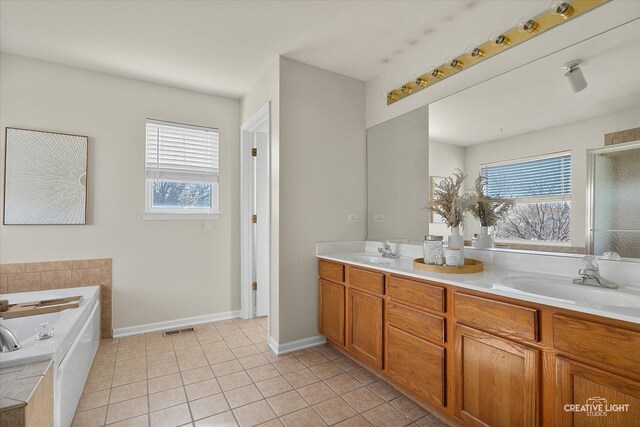 full bath with a garden tub, tile patterned flooring, visible vents, and a wealth of natural light