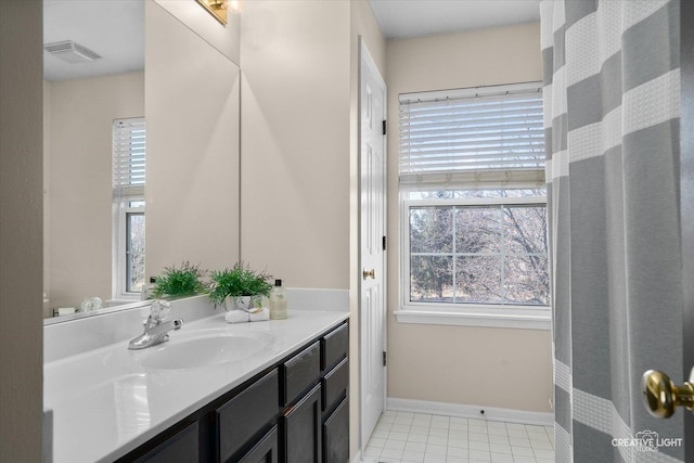 bathroom with visible vents, vanity, baseboards, and tile patterned floors