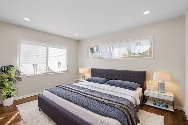 bedroom with dark hardwood / wood-style flooring