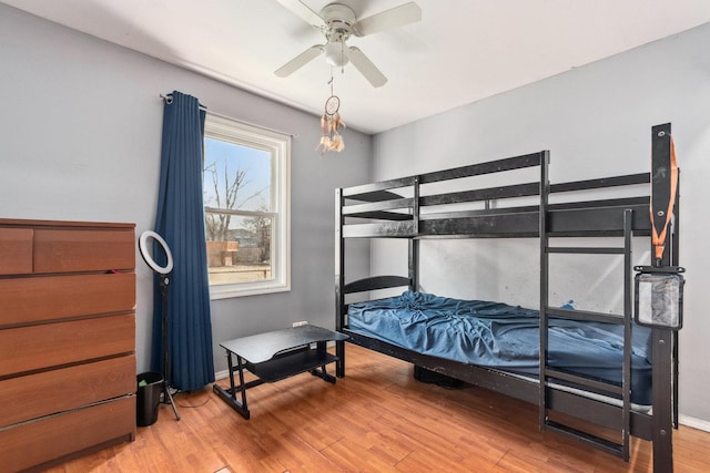 bedroom with wood-type flooring and ceiling fan