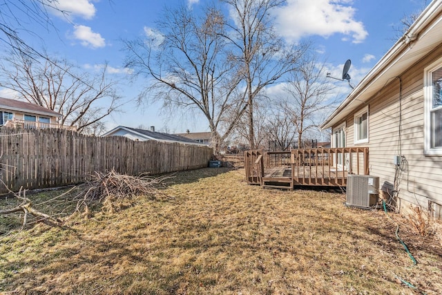 view of yard featuring a wooden deck and central air condition unit