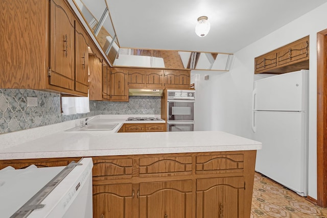 6102 W 64th St, Chicago, IL 60638 - kitchen with freestanding refrigerator, a peninsula, under cabinet range hood, gas cooktop, and a sink