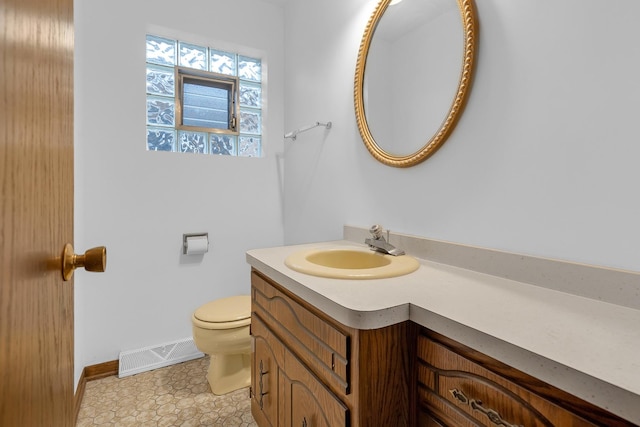 6102 W 64th St, Chicago, IL 60638 - bathroom with toilet, baseboards, visible vents, and vanity