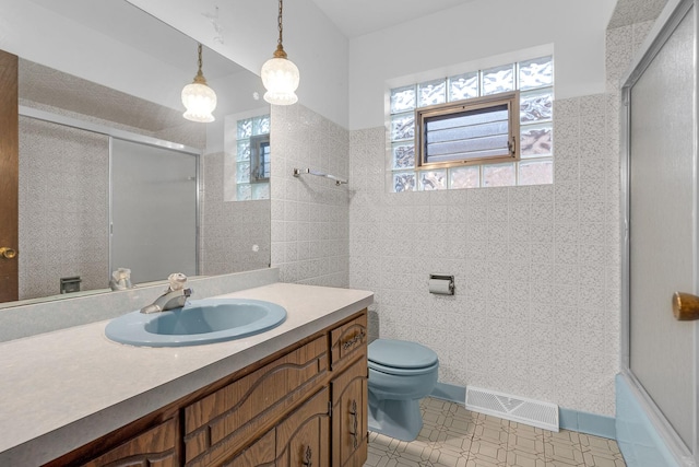 6102 W 64th St, Chicago, IL 60638 - bathroom with tile walls, visible vents, toilet, an enclosed shower, and vanity