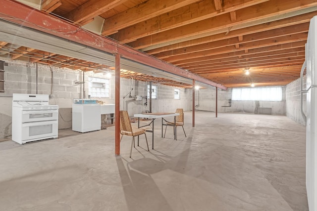 6102 W 64th St, Chicago, IL 60638 - below grade area featuring washing machine and dryer, freestanding refrigerator, and a sink