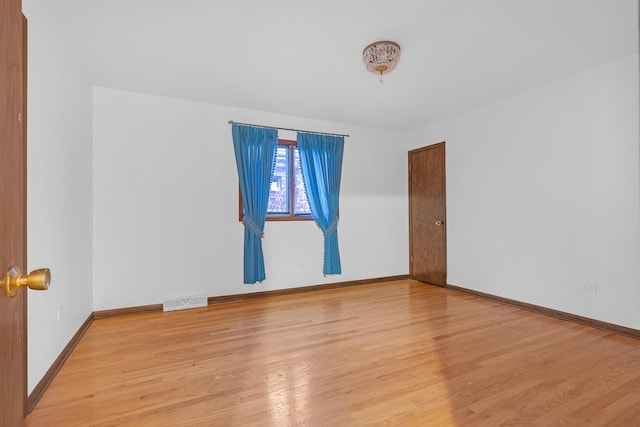 6102 W 64th St, Chicago, IL 60638 - spare room featuring light wood finished floors, visible vents, and baseboards