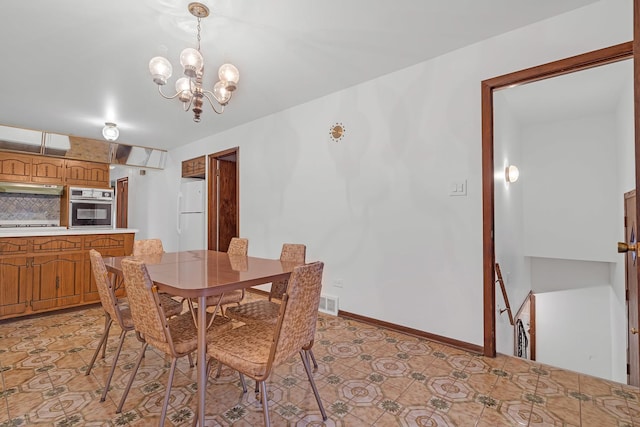 6102 W 64th St, Chicago, IL 60638 - dining area with a chandelier and baseboards