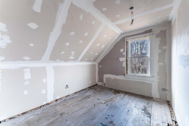 bonus room featuring hardwood / wood-style flooring and lofted ceiling