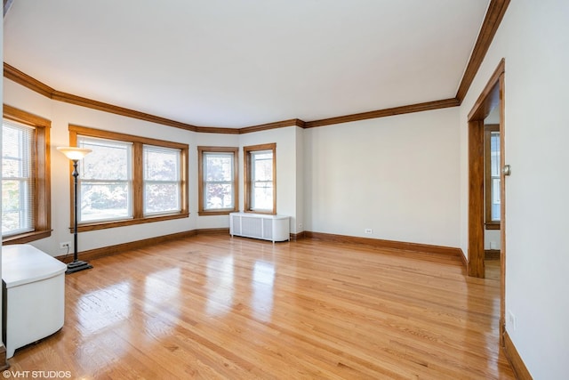 unfurnished living room with crown molding, radiator, and light hardwood / wood-style flooring