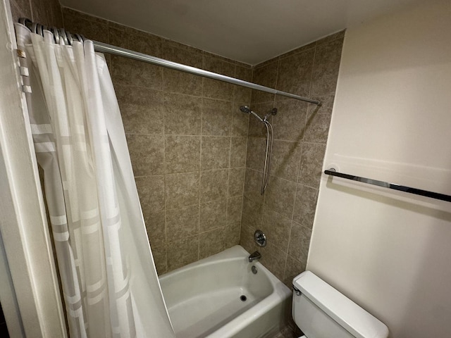 bathroom featuring shower / bath combo and toilet