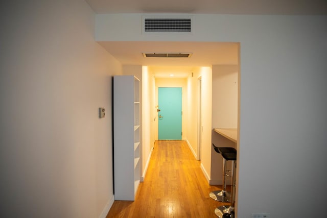 corridor with light wood-type flooring