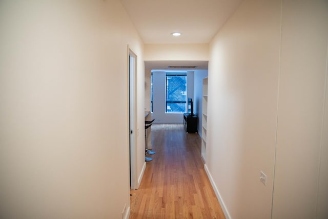 hall with light hardwood / wood-style flooring