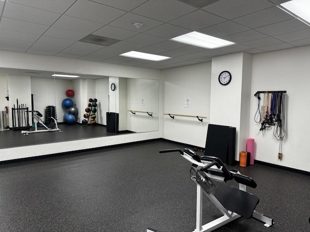 exercise room featuring a paneled ceiling