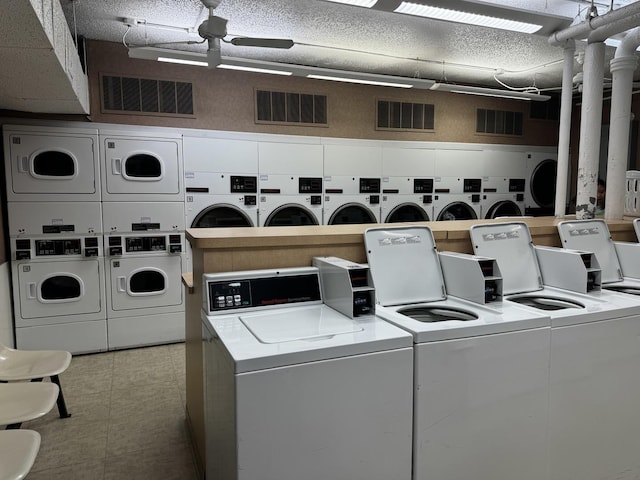 laundry room featuring stacked washing maching and dryer, washing machine and clothes dryer, and ceiling fan